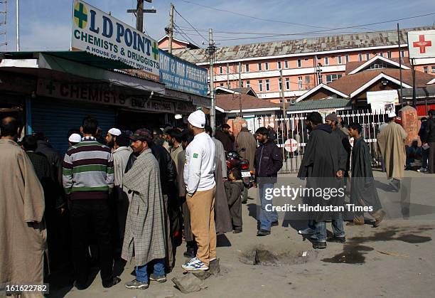 People buying medicines at a medical shop near Lal Ded Hospital after curfew was lifted from some parts of valley after five days on February 13,...