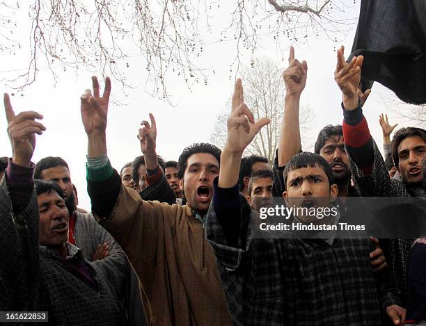 People shout slogan outside the house of Afzal Guru after curfew was lifted in some areas on February 13, 2013 in Sopore some 50 Km from Srinagar,...