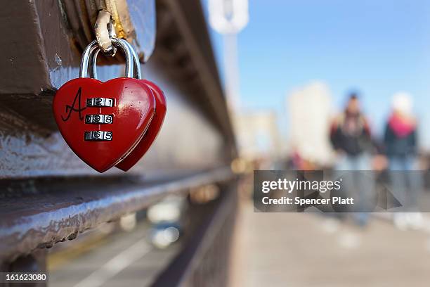 Love lock" is viewed on the Brooklyn Bridge, one of thousands that have been placed along the bridge recently on February 13, 2013 in New York City....