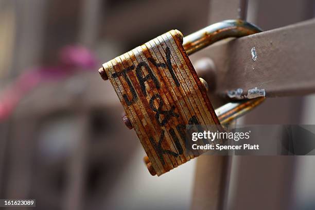 Love lock" is viewed on the Brooklyn Bridge, one of thousands that have been placed along the bridge recently on February 13, 2013 in New York City....