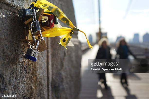 Love locks" are viewed on the Brooklyn Bridge, one of thousands that have been placed along the bridge recently on February 13, 2013 in New York...