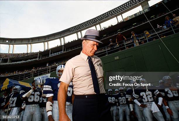 Head coach Tom Landry of the Dallas Cowboys stands with his team before coming onto the field before an NFL football game circa 1978. Landry coached...