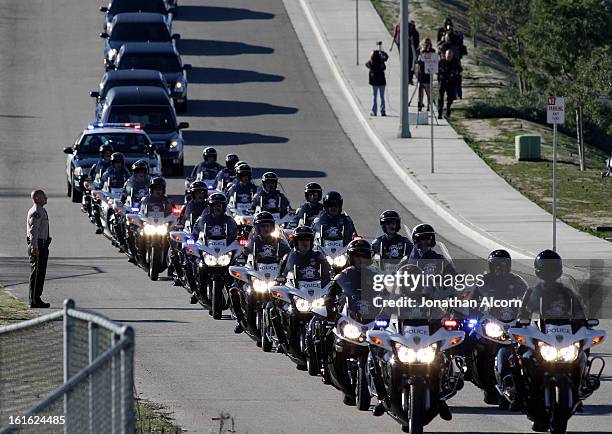 The funeral procession for slain Riverside police Officer Michael Crain arrives at Grove Community Church in Riverside, California, February 13,...