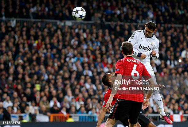 Real Madrid's Portuguese forward Cristiano Ronaldo heads the ball to score during the UEFA Champions League round of 16 first leg football match Real...