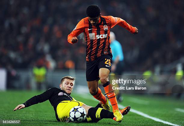 Jakub Blaszczykowski of Dortmund challenges Taison of Donetsk during the UEFA Champions League Round of 16 first leg match between Shakhtar Donetsk...