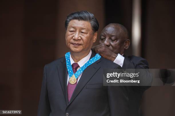 Cyril Ramaphosa, South Africa's president, right, bestows the Order of South Africa to Xi Jinping, China's president, during a pre-BRICS summit state...