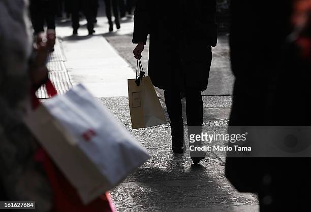 People carry shopping bags on Broadway in Manhattan on February 13, 2013 in New York City. The Commerce Department reported that retail sales were...