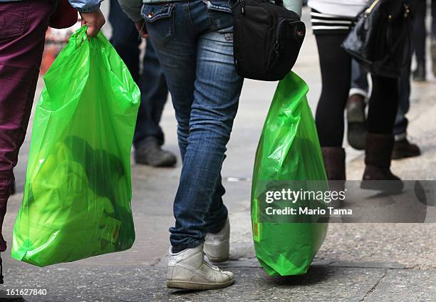 People carry shopping bags on Broadway in Manhattan on February 13, 2013 in New York City. The Commerce Department reported that retail sales were...