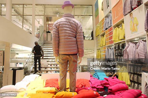 Man carries a shopping bag in a Uniqlo store in Manhattan on February 13, 2013 in New York City. The Commerce Department reported that retail sales...