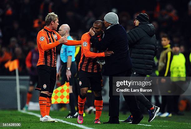 Douglas Costa of Donetsk celebrates with head coach Mircea Lucescu after scoring his teams second goal during the UEFA Champions League Round of 16...