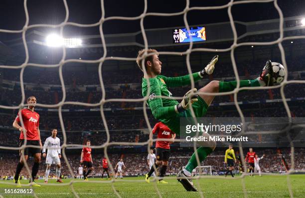 David De Gea of Manchester United makes a save with his foot during the UEFA Champions League Round of 16 first leg match between Real Madrid and...