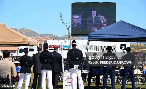 Police officers, friends and family attend a memorial service for slain Riverside police officer Michael Crain at the Grove Community Church in...