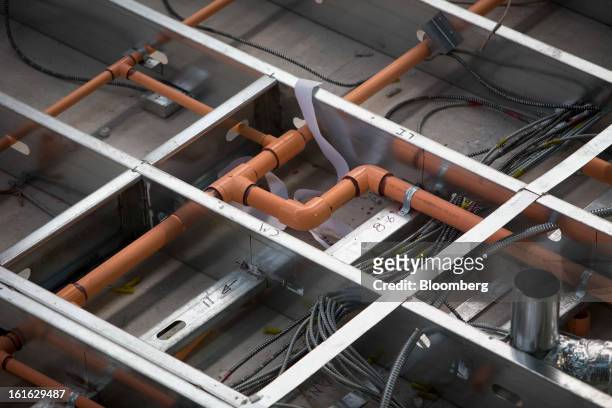 Pipes and electrical cables line the ceiling of a Capsys Corp. Modular housing unit at the Brooklyn Navy Yard in the Brooklyn borough of New York,...