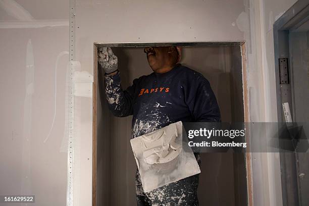 Capsys Corp. Employee works on the drywall in a modular housing unit at the Brooklyn Navy Yard in the Brooklyn borough of New York, U.S., on...