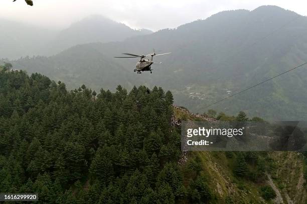 Military helicopter conducts a rescue operation to recover students stuck in a chairlift in the Pashto village of mountainous Khyber Pakhtunkhwa...