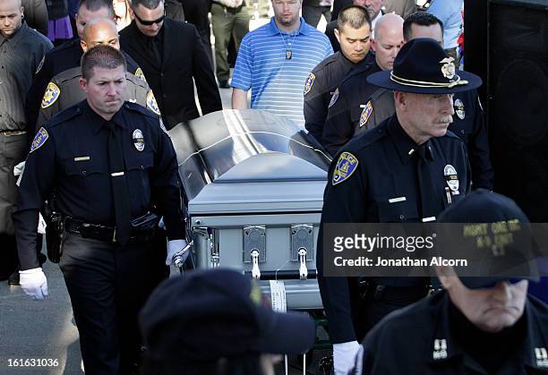 Riverside Police carry the coffin of officer Michael Crain during his committal ceremony at Riverside National Cemetery on February 13, 2013 in...