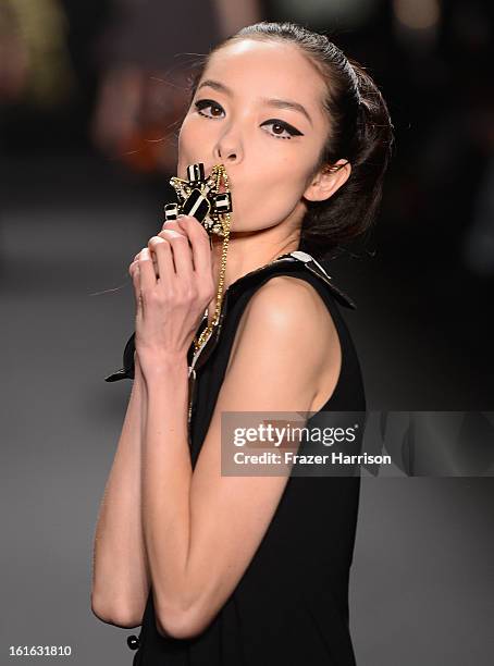 Model walks the runway at the Anna Sui Fall 2013 fashion show during Mercedes-Benz Fashion Week at The Theatre at Lincoln Center on February 13, 2013...