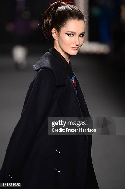 Model walks the runway at the Anna Sui Fall 2013 fashion show during Mercedes-Benz Fashion Week at The Theatre at Lincoln Center on February 13, 2013...