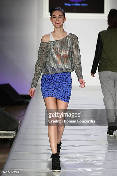 Model walks the runway during the Boy Meets Girl by Stacy Igel the "Invasion Collections" Fashion Show at STYLE360 presented by Conair Fashion...