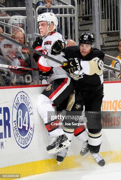 Tyler Kennedy of the Pittsburgh Penguins collides with Andre Benoit of the Ottawa Senators on February 13, 2013 at Consol Energy Center in...