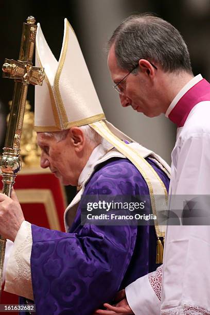 Pope Benedict XVI is helped as he leads the Ash Wednesday service at the St. Peter's Basilica on February 13, 2013 in Vatican City, Vatican. Ash...