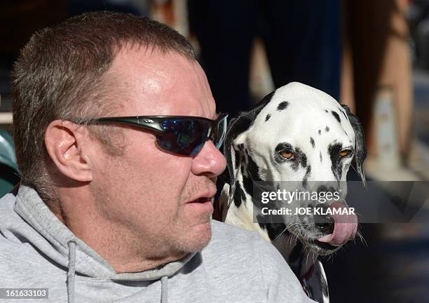 Rick Heltebrake, the man who called police informing them that fugitive Christopher Dorner had hijacked his car, talks to the media with his dog Suni...