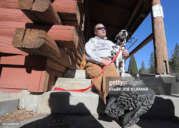 Rick Heltebrake, who called police informing them that fugitive Christopher Dorner had hijacked his car, talks to the media with his dog Suni about...