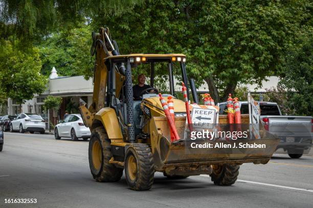 Heavy machinery drives down the street in downtown Ojai, where a 5.1 earthquake occurred amid a historic tropical storm Hilary in Ojai Monday, Aug....