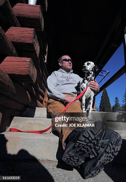 Rick Heltebrake, who called police informing them that fugitive Christopher Dorner had hijacked his car, talks to the media with his dog Suni about...