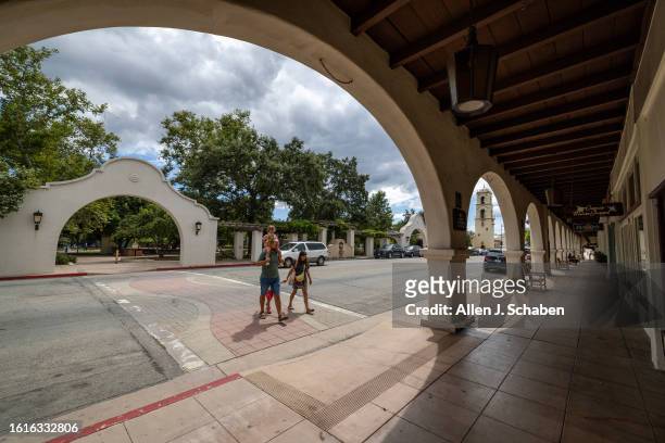 People walk across the street downtown Ojai, where a 5.1 earthquake occurred amid a historic tropical storm Hilary in Ojai Monday, Aug. 21, 2023.