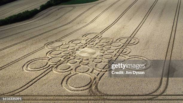 An aerial view of a geometric crop circle, measuring approximately 100 metres, in a field of wheat in Hampshire on July 29, 2023 near Winchester,...