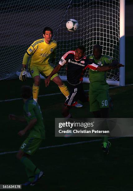 Goalkeeper Michael Gspurning of the Seattle Sounders follows the play as Juan Toja of the New England Revolution goes up for a header during the...