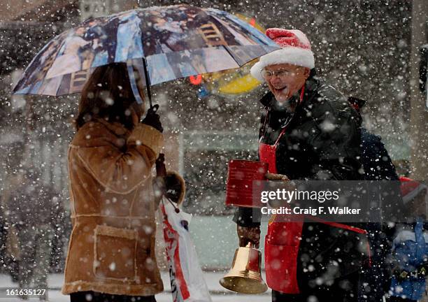 The Salvation Army volunteer, Merrill Fie, uses the new bell he was awarded for his 50 years of service while working on the 16th street mall....