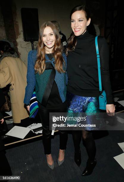 Actresses Elizabeth Olson and Liv Tyler attend the Proenza Schouler fall 2013 fashion show during Mercedes-Benz Fashion Week on February 13, 2013 in...