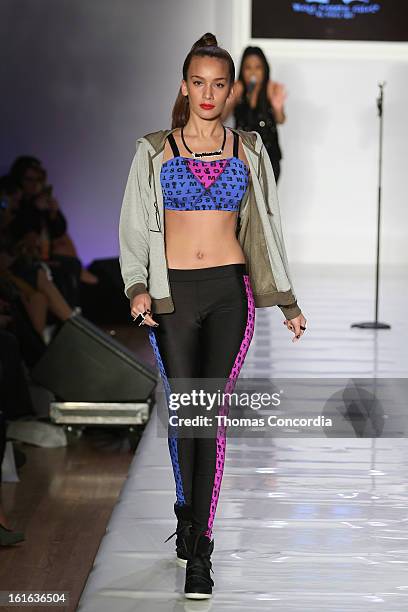 Model walks the runway during the Boy Meets Girl by Stacy Igel the "Invasion Collections" Fashion Show at STYLE360 presented by Conair Fashion...