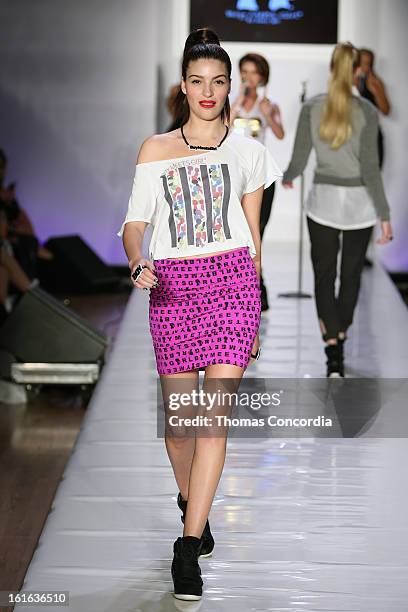 Model walks the runway during the Boy Meets Girl by Stacy Igel the "Invasion Collections" Fashion Show at STYLE360 presented by Conair Fashion...