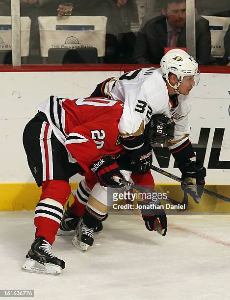 Toni Lydman of the Anaheim Ducks grabs Brandon Saad of the Chicago Blackhawks by the head at the United Center on February 12, 2013 in Chicago,...