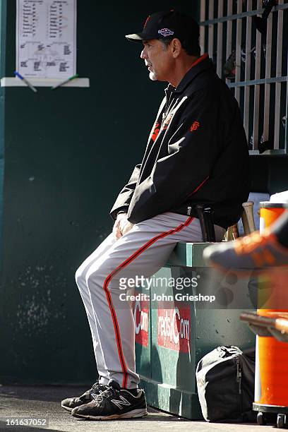 Manager Bruce Bochy of the San Francisco Giants looks on from the dugout during Game 4 of the National League Division Series against the Cincinnati...