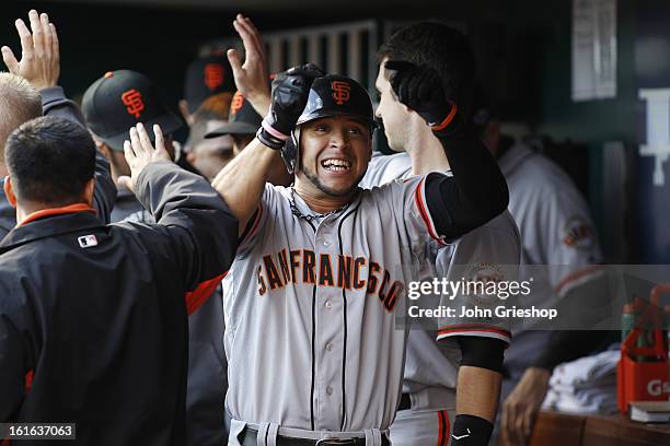 Gregor Blanco of the San Francisco Giants celebrates in the dugout after hitting a two run home run in the top of the second inning during Game 4 of...