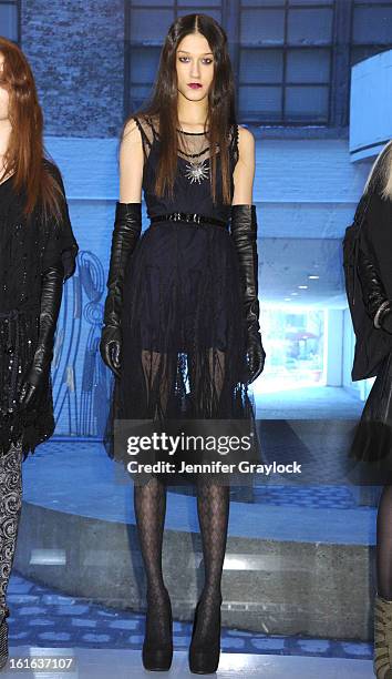 Models pose during the Diego Binetti Fall 2013 Mercedes-Benz Fashion Presentation held at Westbeth Gallery on February 13, 2013 in New York City.