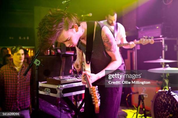 Matthew Healy and Ross MacDonald of The 1975 perform on stage at The Bodega Social Club on February 13, 2013 in Nottingham, England.