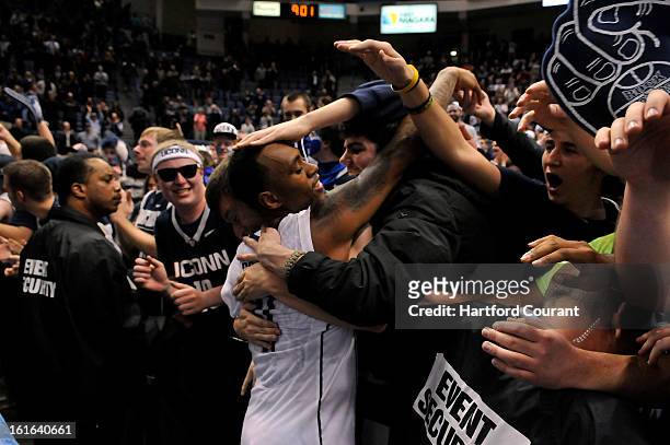 Connecticut's Ryan Boatright is mobbed by the student section after UConn defeated Syracuse, 66-58, on Wednesday, February 13 at the XL Center in...