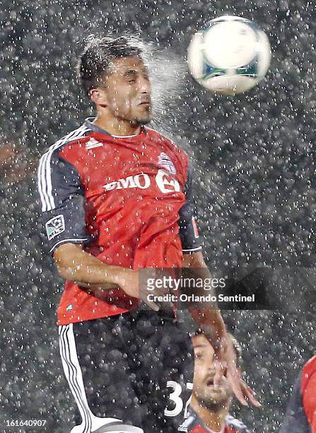 Toronto FC's Andrew Wiedeman leaps to head the ball in the heavy rain against Orlando City Soccer at the Walt Disney World Pro Soccer Classic at the...