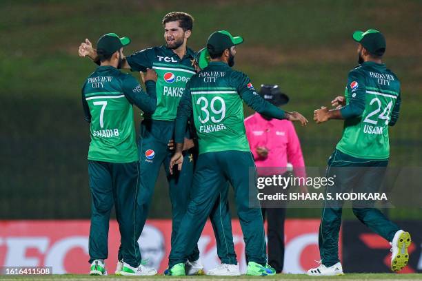 Pakistan's Shaheen Afridi celebrates with teammates after taking the wicket of Afghanistan's Rahmat Shah during the first one-day international...