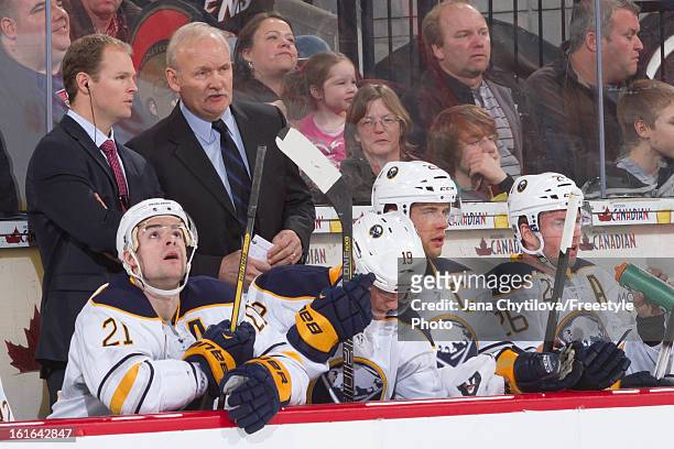 Assistant Coach Kevyn Adams and head coach Lindy Ruff of the Buffalo Sabres chat behind the bench, during an NHL game against the Ottawa Senators, at...