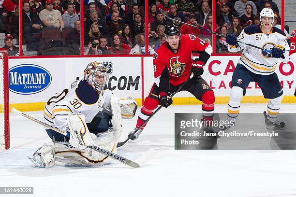 Team mates Ryan Miller and Tyler Myers of the Buffalo Sabres defend against Jim O'Brien of the Ottawa Senators, during an NHL game at Scotiabank...