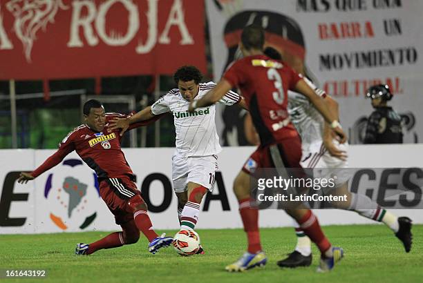 Wellington Nem of Fluminense fights for the ball with Antonio da Silva of Caracas FC during a match between Caracas FC and Fluminense as part of the...