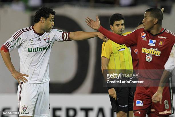 Fred of Fluminense argues with Edgar Jimenez of Caracas FC during a match between Caracas FC and Fluminense as part of the 2013 Copa Bridgestone...