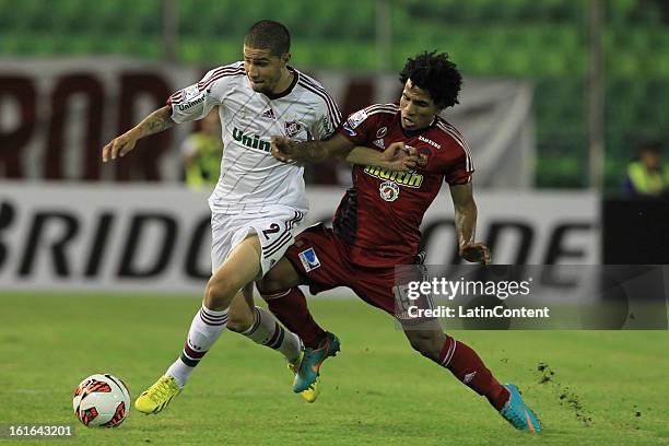 Bruno of Fluminense fights for the ball with Romulo Otero of Caracas FC during a match between Caracas FC and Fluminense as part of the 2013 Copa...