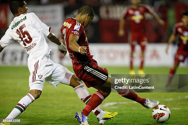Edwin Peraza de Caracas FC fights for the ball with Anderson of Fluminense during a match between Caracas FC and Fluminense as part of the 2013 Copa...